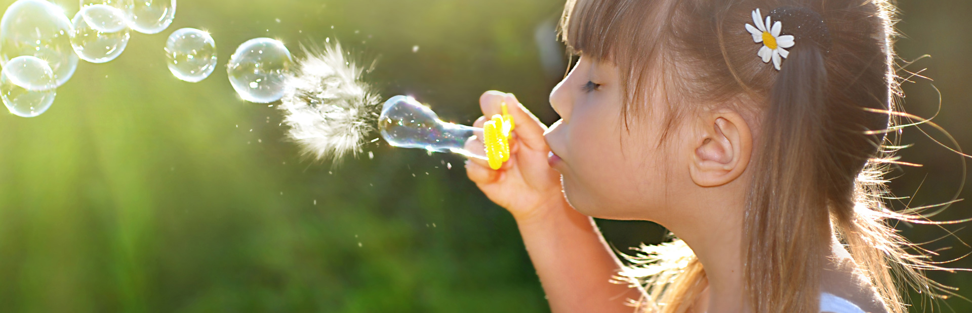 Child blowing bubbles and having fun